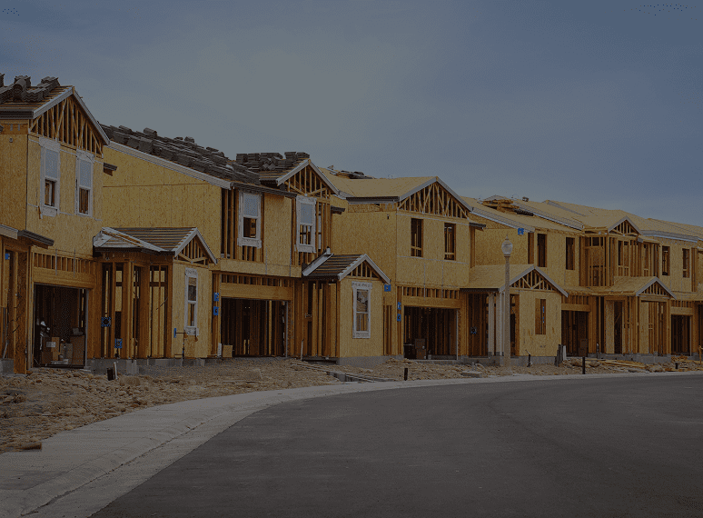 Houses under construction along a street.