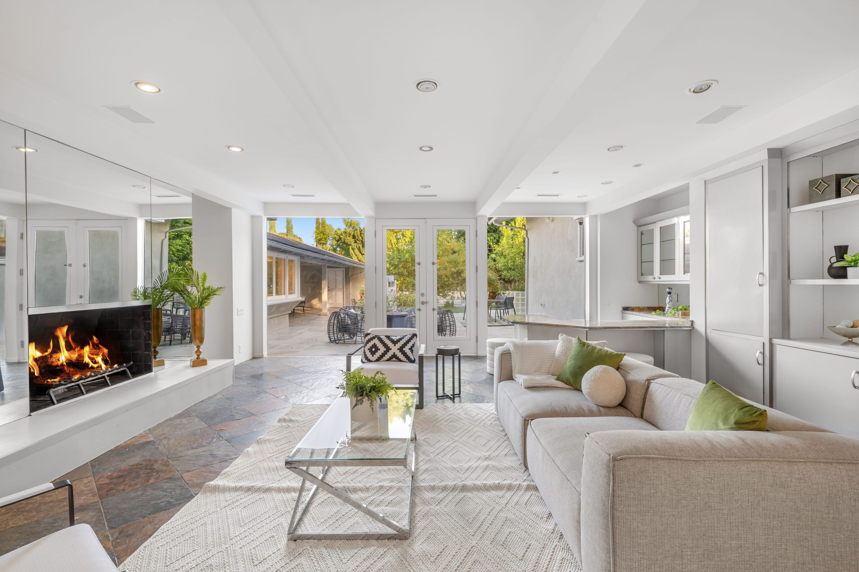 Modern living room with fireplace and outdoor view.