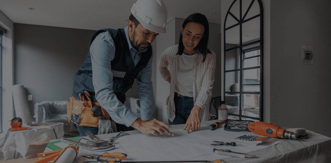 Architect and client reviewing renovation plans.